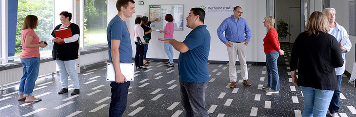 Mehrere Personen diskutieren in kleinen Gruppen